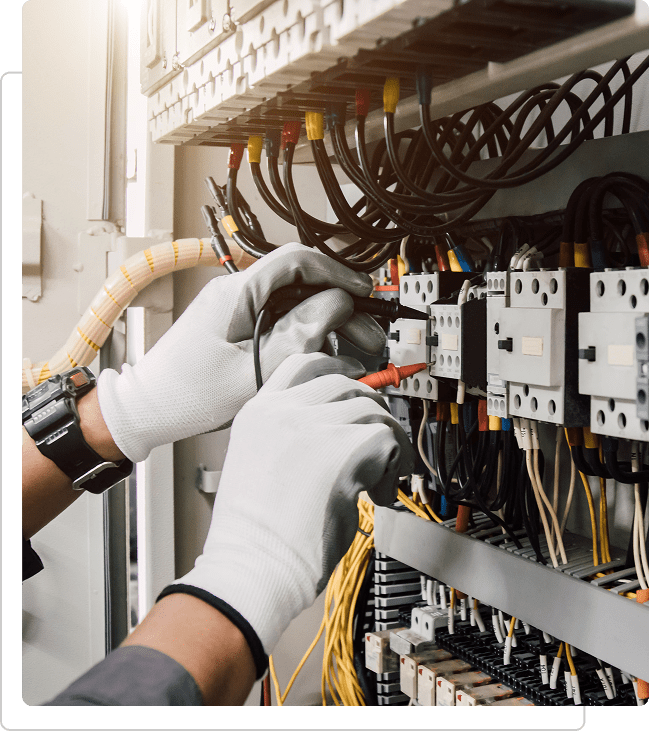 img Electrician working on electrical control panel.